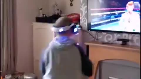Guy Playing VR Game For First Time Punches TV And Walks Into its Screen