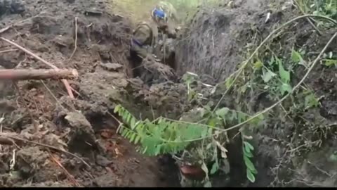 Soldiers of the Ukrainian Armed Forces rescue a comrade who was buried in the ground