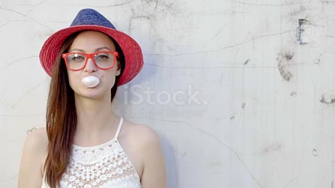 Trendy fashionable girl blows big bubble from bubble gum stock video