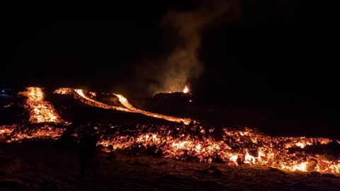 Guy Casually Walk by Lava as He Texts in the Evening