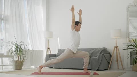 Young man practicing yoga at home