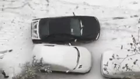 Cars sliding in snow in Tehran