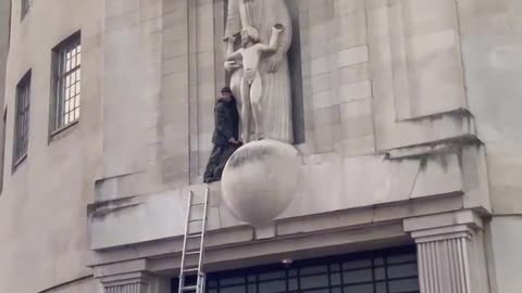 UK: Someone has climbed onto the BBC building and smashing up the Eric Gill pedo statue