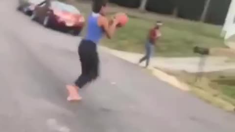 Girl in blue shirt throws basketball hits face