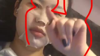 Girl with facemask on tries to do the disneyland channel sign