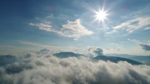 Sun flare over the cloudy sky in the mountains