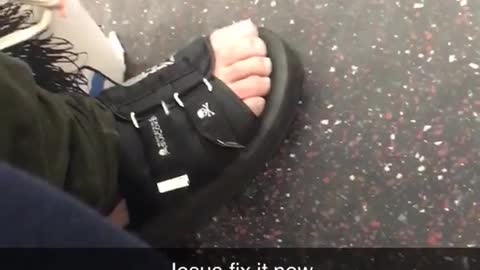 Man wears skull sandals on subway train