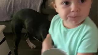 Trying to feed her Boxer Faith