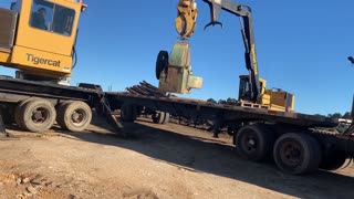 unloading a Sawmill Chipper with two Knucklebooms