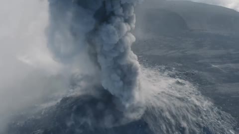 Drone capture incredible footage of man running towards erupting volcano