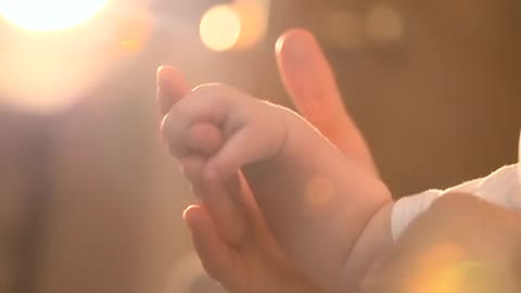 Cute baby and a caring hand you can't miss