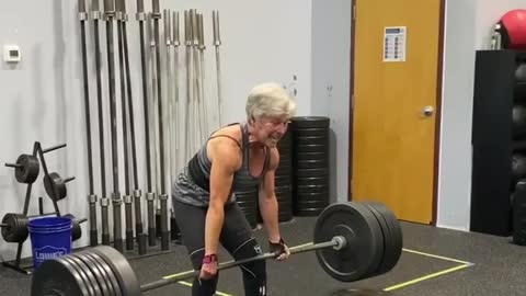 Elderly Woman Deadlifts Heavy Weights