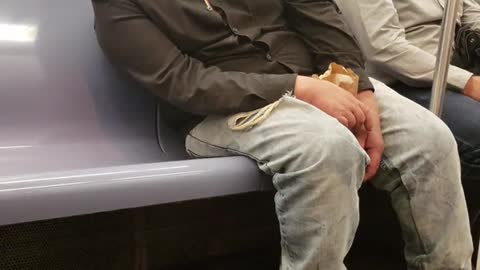 Guy ny hat falling asleep leaning subway train seat