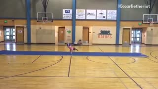Girl in pink tries to do flips but falls down