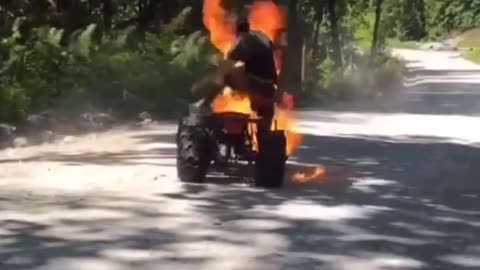 atv catches fire with guy riding it