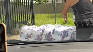 Couple Loads Pallets of Toilet Paper into Van