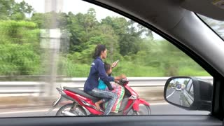 Woman Texts While Driving Scooter