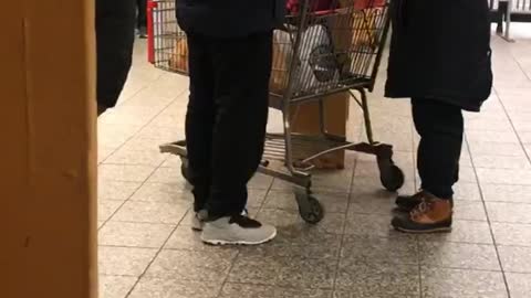 Woman with shopping cart on subway platform