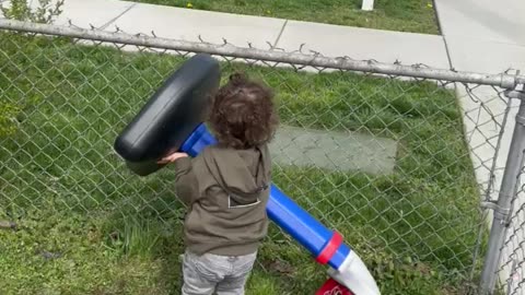 Toddler trying to escape the yard