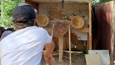 Guy Throws Spear Through Ring and Pins Them Both to Target
