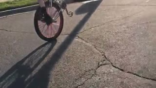 Guy recording kid in white doing cool tricks on bike wheelie runs into car while recording