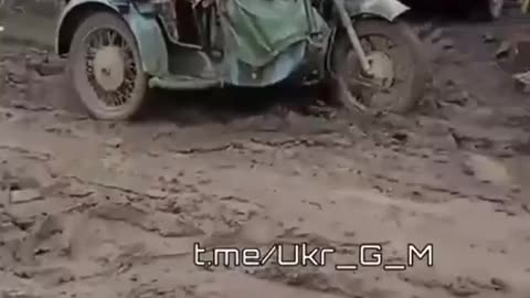 Ukrainian soldiers driving a motorcycle with sidecar, they mounted a machine gun to it