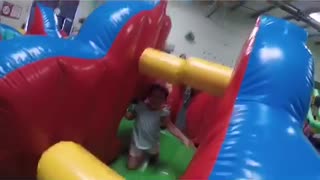 Little girl runs into obstacle in bouncy house, hollaback girl