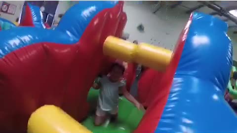 Little girl runs into obstacle in bouncy house, hollaback girl