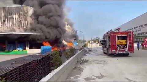 Fire at Carrefour Logistics Center in Taoyuan, Taiwan, smoke billows into the sky