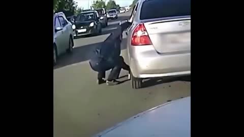 guy saves a cat from under the wheels of a car