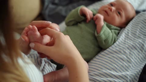 A Mother Massaging Her Baby's Feet