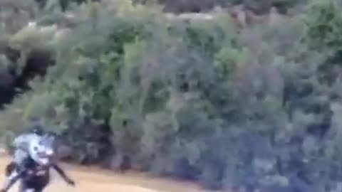 Guy crashes motorcross bike in large river of mud