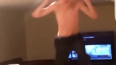 No shirt boy couch jump hit ceiling