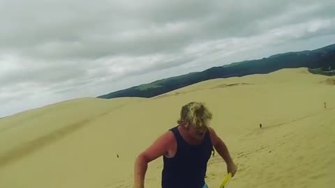 Sand boogie board faceplant