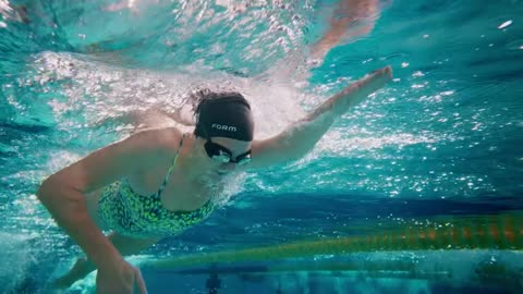 FORM Swim Goggles with see-through smart display show your metrics while you swim.