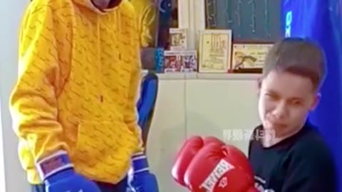 Dad teaching his son how to box