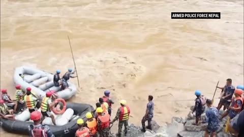 Rescuers in Nepal search for two buses swept into river with more than 50 people on board.mp4