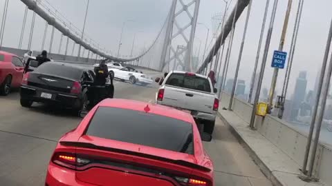 Cars block bridge while dangerously making doughnuts