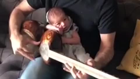 2-Week-Old Baby Relaxes While Dad Jams Soothing Music