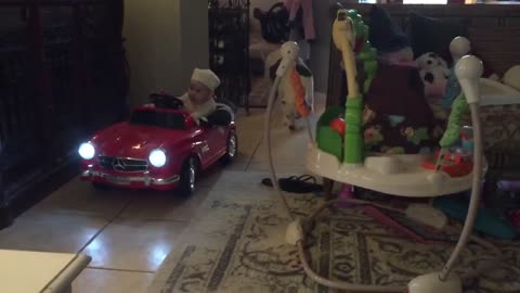 Baby Takes A Ride Around The Sofa In Toy Mercedes