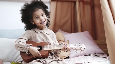 A beautiful girl playing the lute.