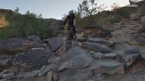 Guy mountain biking falls off bike