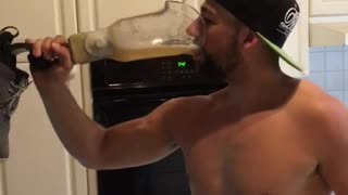 Man in hat drinks beer from prosthetic leg