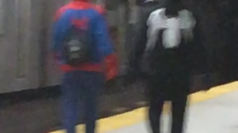 Two guys in spider man and venom sweaters