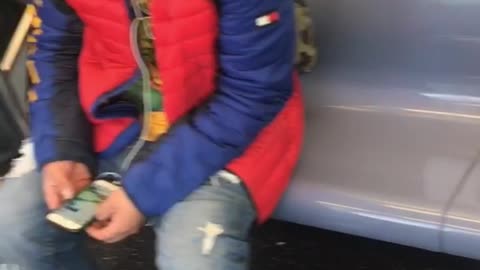 Man sits next to poop smear on subway seat
