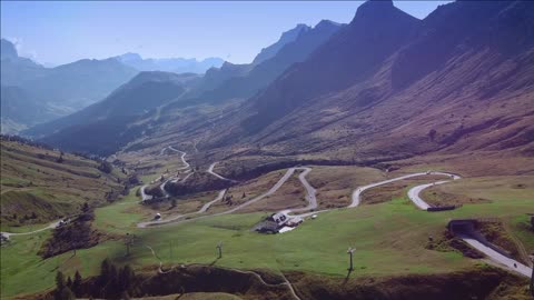 breathtaking view of dolomites mountains waving road and valley in sun in italy
