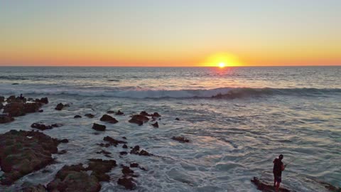 Beach sunset of waves and fishermen