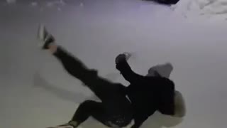 Girl in all black slips on snow doesnt drop drink