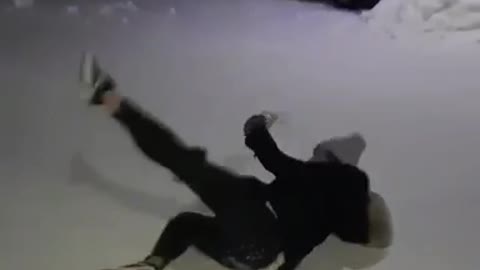 Girl in all black slips on snow doesnt drop drink