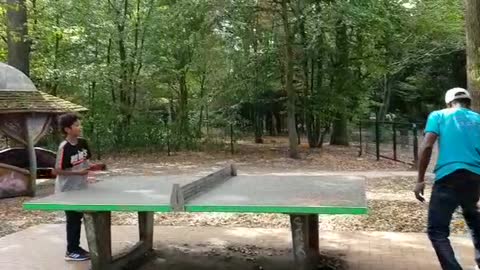 FATHER AND SON PLAYING TENNIS BALL TOGETHER